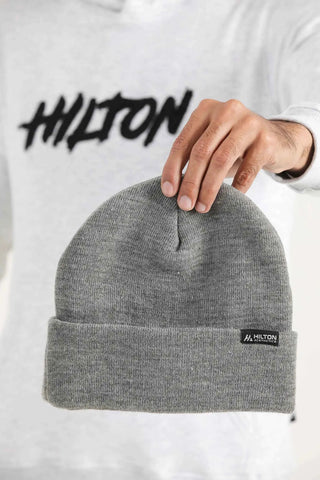 Grey Hilton Aesthetics foldover beanie with ribbed texture and woven logo tag