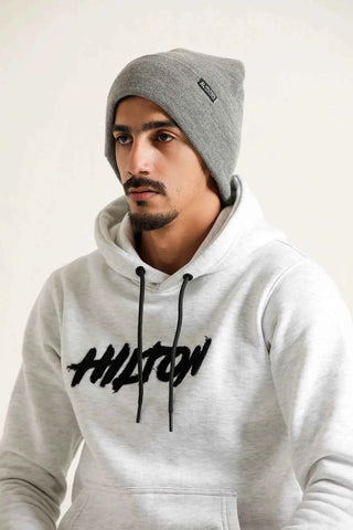 Man wearing a grey Hilton Aesthetics foldover rib-knit beanie, side view