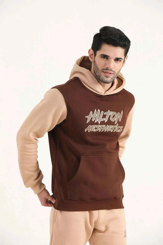 Hilton Aesthetics Signature Two Tone Hoodie angled front view in brown with contrast design and kangaroo pocket