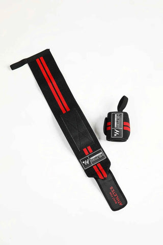 Black and red Hilton Aesthetics lifting wrist wrap with thumb loop, flat-lay view