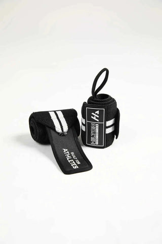 Pair of black Hilton Aesthetics wrist wraps rolled with raised rubber logo